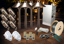 Load image into Gallery viewer, Outdoor LED landscape lighting kit with four ground-mounted metal post lights, eight wall-mounted spotlight heads, white LED driver modules, small LED chips, mounting hardware, wire spool, and pliers on a dark patio background.
